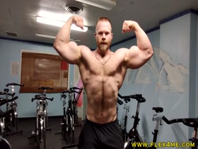 Pumping up super massive veiny biceps in the gym